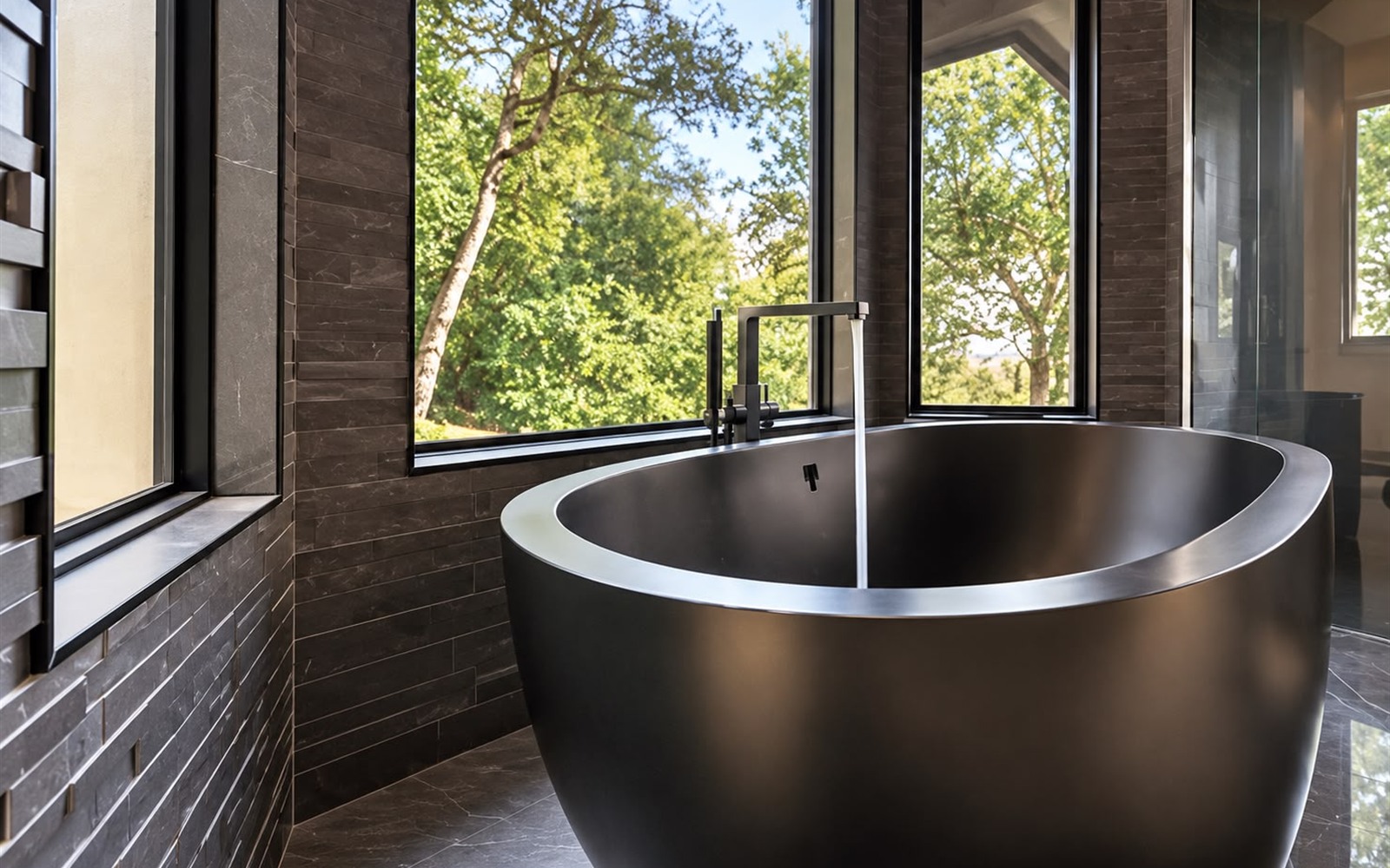 Finished luxury bathroom with matte-black freestanding soaking tub and running water