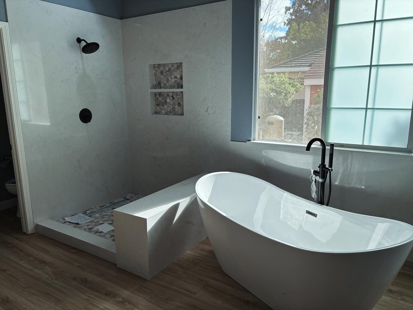 Finished bathroom remodel with a freestanding tub by Prime Time Plumbing