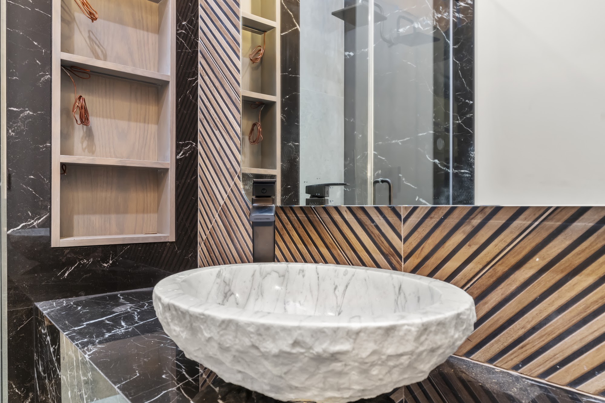 Finished carved marble stone vessel sink with modern matte-black faucet
