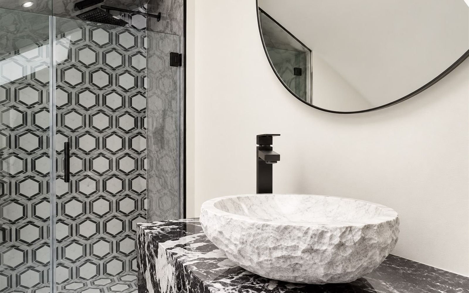 Finished carved marble stone vessel sink with modern matte-black faucet